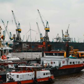 a large boat in the water next to other boats