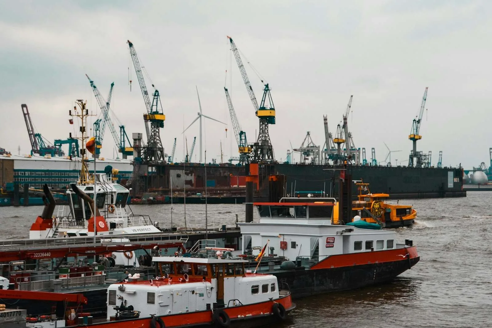 a large boat in the water next to other boats